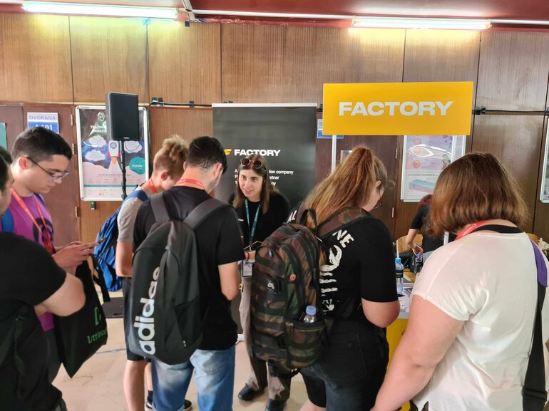 students at factory booth dump days